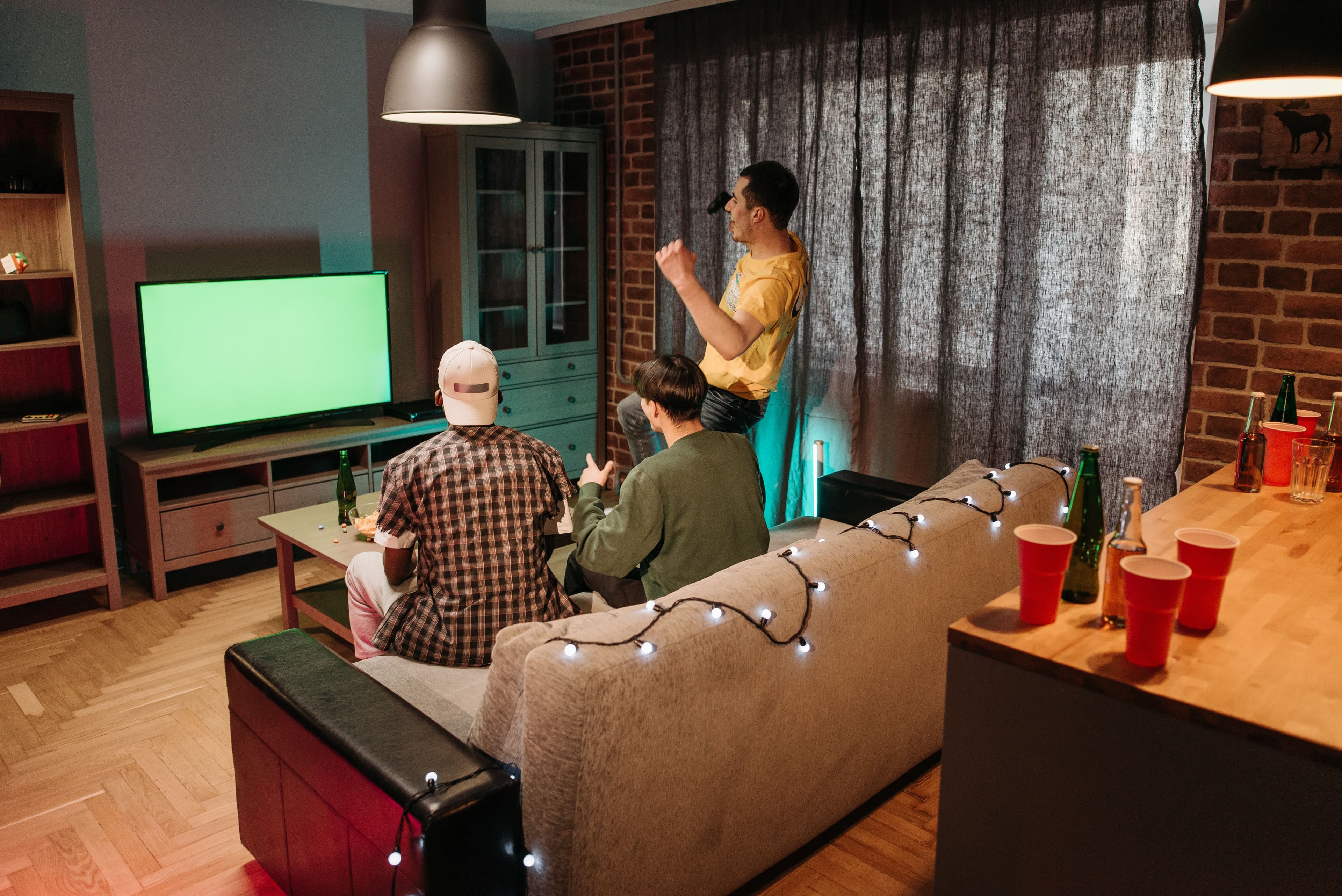 A group of friends enjoying a gaming night in a cozy living room with ambient lighting.